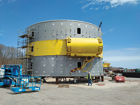 Photo 2. In this picture, I am standing (5′ 9″) next to the generator winding enclosure that has a diameter of 16 m (50 ft).