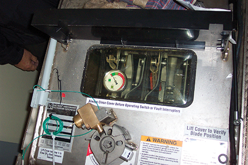 Photo 6. The viewing window of a 38 kV SF6 (sulfur hexafluoride) switch.