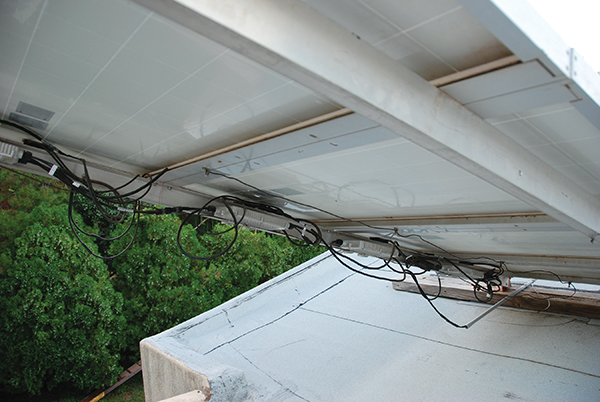Photo 6. Improperly secured module wiring will be subject to wind-driven future damage.