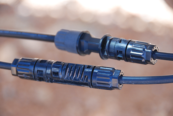 Photo 7. Bottom: Connectors from the same manufacturer/series properly paired for a code-compliant installation. Top: Connectors from two different manufacturers improperly paired, resulting in a certification violation and a Code violation and a potential safety hazard.